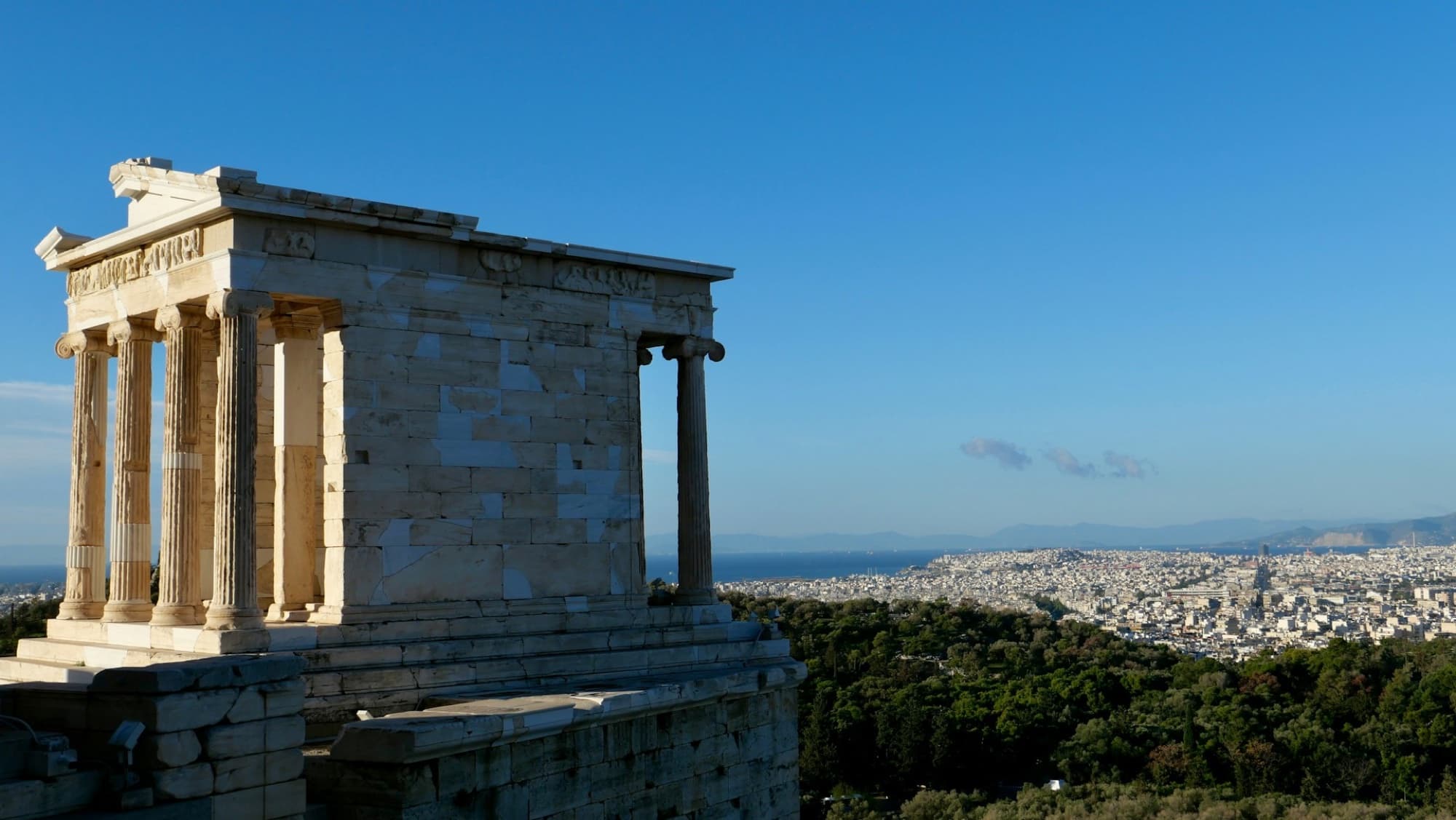 The Temple of Athena Nike on the Acropolis overlooking Athens and the coastline