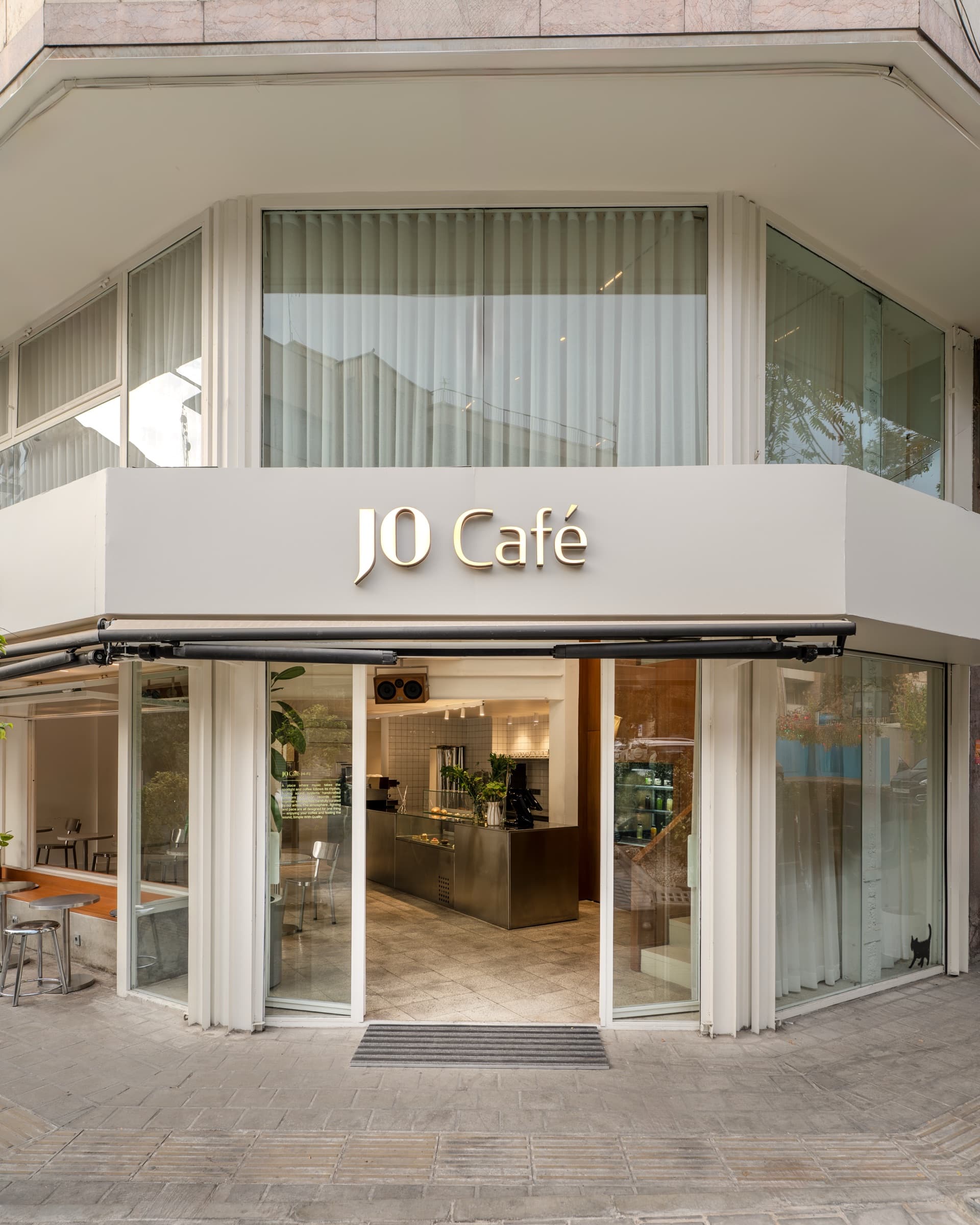 JO Café storefront entrance with illuminated signage